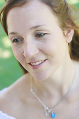 Image showing Close-up portrait of a happy attractive woman outdoors.