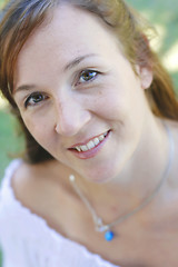 Image showing Close-up portrait of a happy attractive woman outdoors.