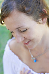 Image showing Close-up portrait of a happy attractive woman outdoors.