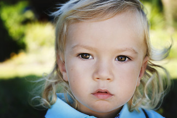 Image showing Close-up portrait of a serious looking little boy.