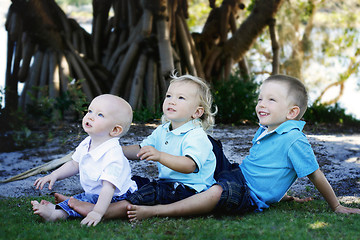 Image showing Three happy brothers together outdoors.