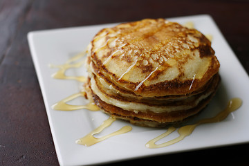 Image showing Stack of pancakes with honey.