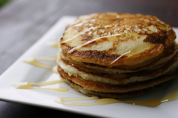 Image showing Stack of pancakes with honey.