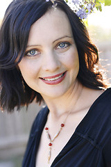 Image showing Portrait of a beautiful woman with blue eyes wearing a black out