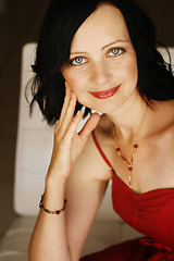 Image showing Portrait of a beautiful woman in a red outfit.