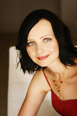 Image showing Portrait of a beautiful woman in a red outfit.