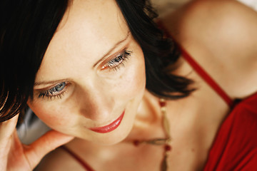 Image showing Portrait of a beautiful woman in a red outfit.