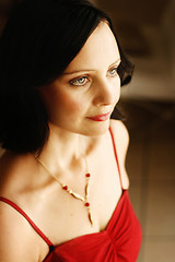 Image showing Portrait of a beautiful woman in a red outfit.