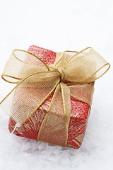 Image showing Christmas gift with red wrapping and decorative bow.