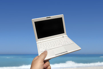 Image showing White small Laptop on the beach