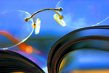 Image showing Close up on a pair of Glasses and the Magazine