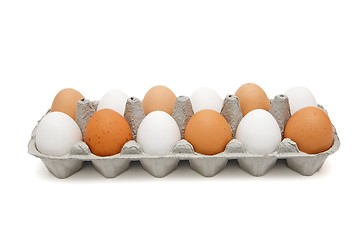 Image showing White and brown eggs in a paper box isolated