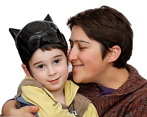 Image showing Mother embraces five year son who wears a mask on his head isolated