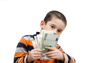 Image showing Cute little boy hides behind a fan of banknotes isolated