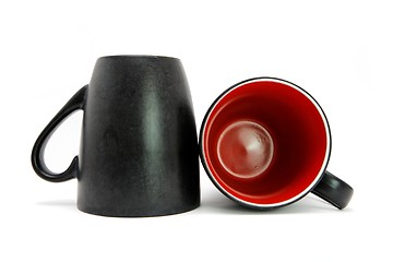 Image showing Two black coffee cups down and on side isolated