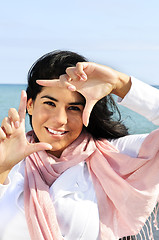 Image showing Beautiful young woman framing her face