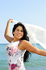 Image showing Beautiful young woman at beach with white scarf