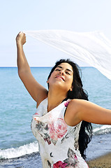 Image showing Beautiful young woman at beach with white scarf