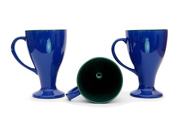 Image showing Two standing and one lying blue high coffee cups isolated