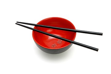 Image showing Chopsticks on  red and black bowl with kanji inscription isolated