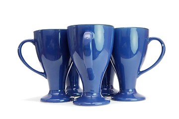 Image showing Five blue high coffee cups standing with handles out isolated