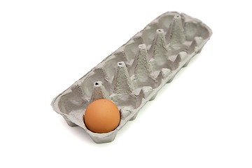 Image showing Last remaining brown egg in a paper box isolated