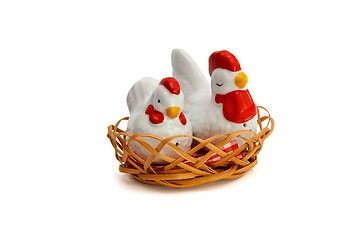 Image showing Two porcelain saltsellars in shape of hens in the nest isolated