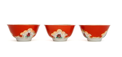 Image showing Three small red porcelain bowls isolated