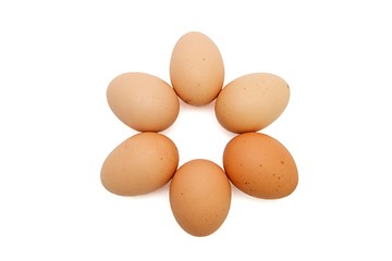 Image showing Six-pointed star of six brown eggs isolated