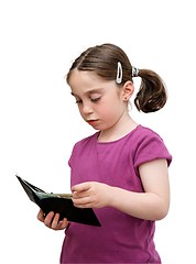 Image showing Serious seven years girl with pigtails holds a wallet with money isolated