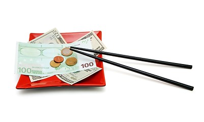 Image showing Money bills and coins on red square plate with chopsticks isolated