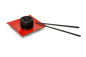 Image showing Objective lens on square oriental plate with chopsticks isolated