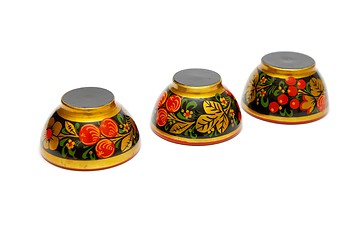 Image showing Three painted Russian wooden cups upside down isolated