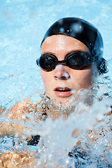 Image showing Swimmer in the water with spray