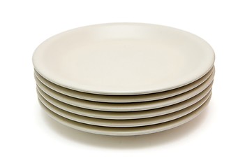 Image showing Stack of plain beige dinner plates isolated