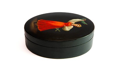 Image showing Oval black casket painted with dancing female peasant isolated