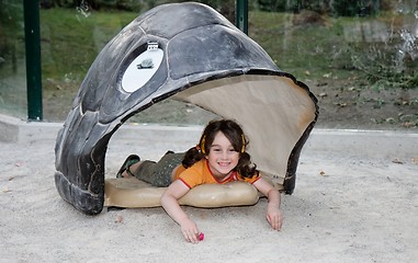 Image showing Cute little girl lies in the turtle shell
