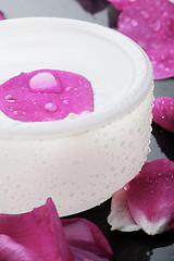 Image showing Pink flower petal and water bowl decoration.