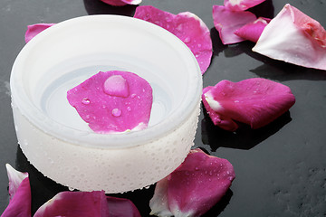 Image showing Pink flower petal and water bowl decoration.