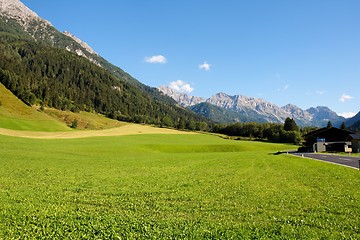 Image showing Alpine rural landscape: mountains and meadows