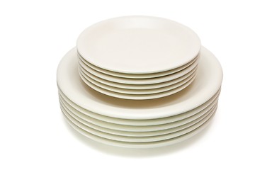 Image showing Stack of plain beige dinner plates and saucers isolated