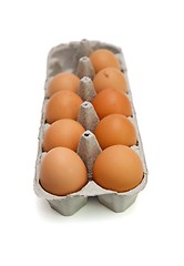 Image showing Nine brown eggs in a paper box isolated