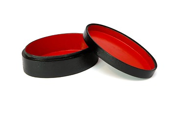 Image showing Oval black casket with red lining and cover isolated