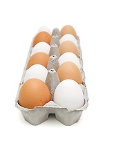 Image showing White and brown eggs in a paper box in a chessboard order isolated