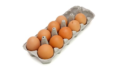 Image showing Nine brown eggs in a paper box isolated