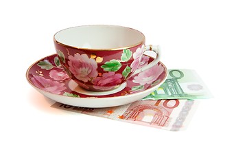 Image showing Tea service stands on euro banknotes isolated 