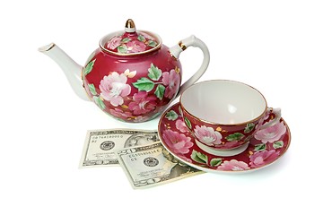 Image showing Tea service stands on dollar banknotes isolated 