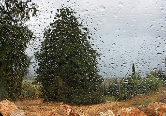 Image showing Rainy landscape viewed  through a car window