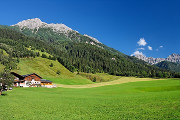 Image showing Alpine landscape in Austria: mountains, forests, meadows and a farm