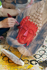 Image showing Painting a Buddha image